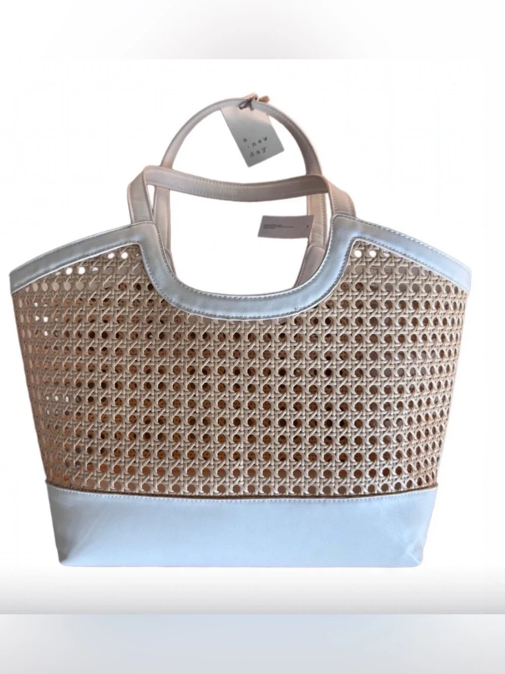 A New Day Straw Caning Tote Bag natural woven cane design white trim detailing.